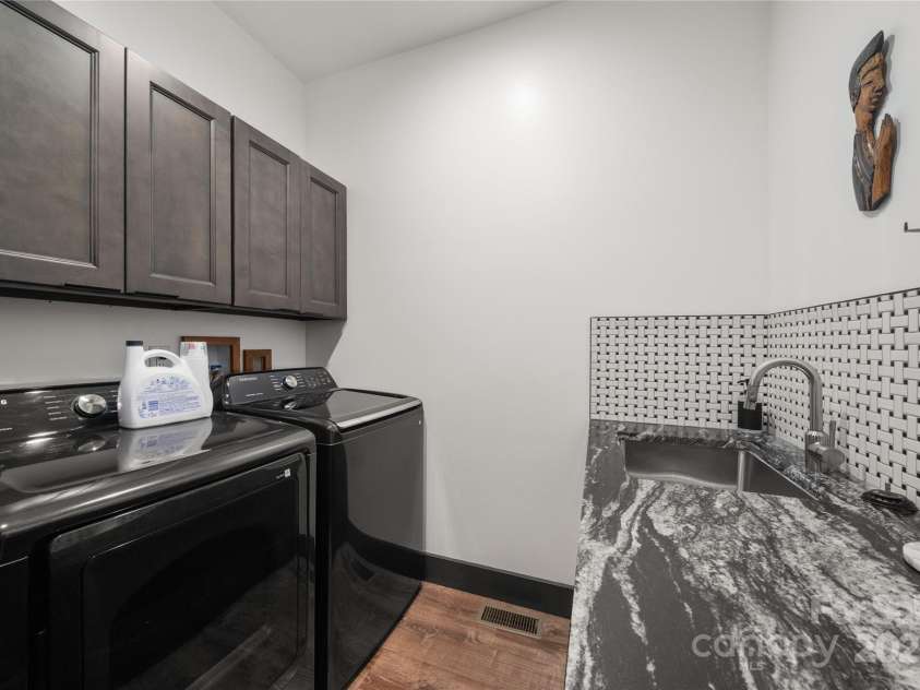 41 Ben Lippen School Road, Asheville, NC 28806.  MLS# CAR4316852, YatesRealty ID 28296. Large utility, mud, laundry room with sink and ample folding and storage space perfectly located adjacent to garage entry and massive double door storage closet.