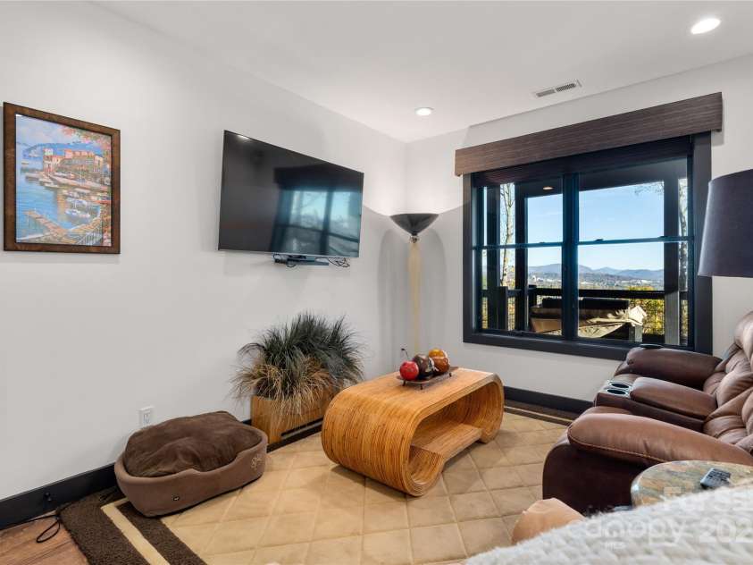 41 Ben Lippen School Road, Asheville, NC 28806.  MLS# CAR4316852, YatesRealty ID 28296. Lower level sitting lounge.