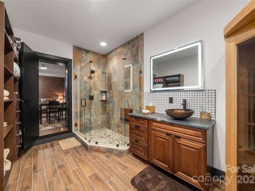 41 Ben Lippen School Road, Asheville, NC 28806.  MLS# CAR4316852, YatesRealty ID 28296. Lower level spa inspired luxury full bath with sauna.