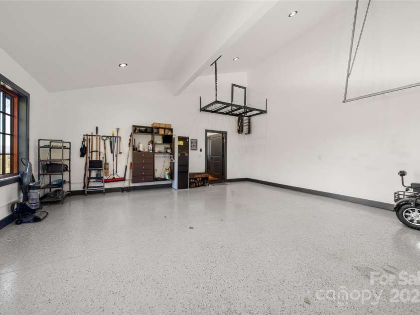 41 Ben Lippen School Road, Asheville, NC 28806.  MLS# CAR4316852, YatesRealty ID 28296. Oversize gleaming epoxy garage. Pull down ladder above right leads to huge partially finished full height attic. 
