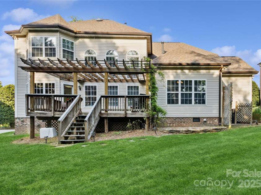 551 Hemmings Place, Concord, NC 28027.  MLS# CAR4244945, YatesRealty ID 28312. Rear Exterior and  Lush Backyard