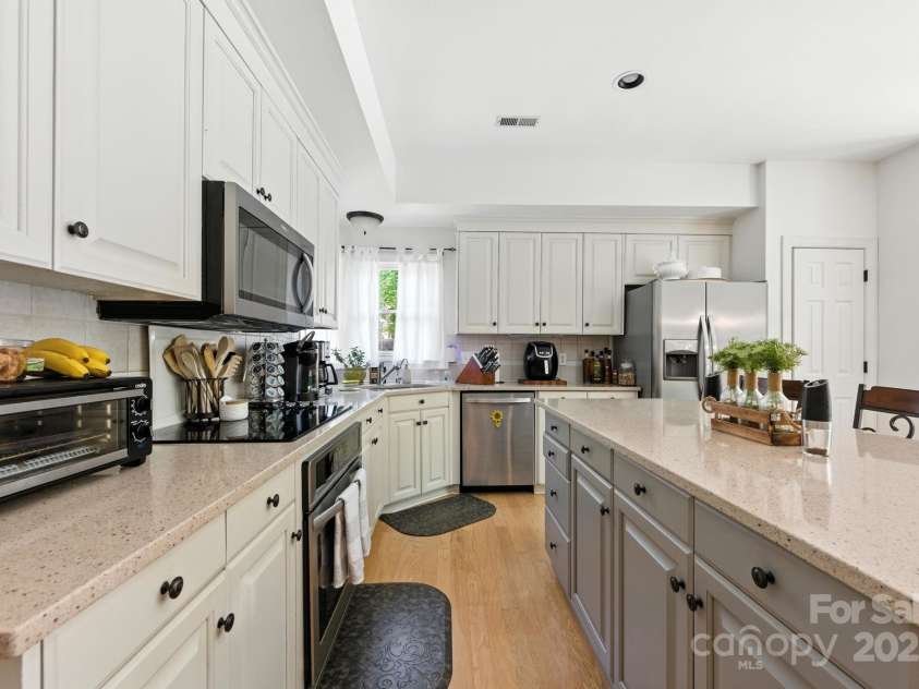 7014 Walton Heath Lane, Charlotte, NC 28277.  MLS# CAR4274206, YatesRealty ID 28318. The updated Kitchen offers quartz countertops, a sizable island and SS appliances - Refrigerator conveys.