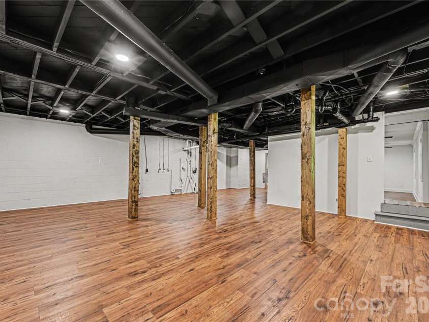 716 Grandview Drive, Concord, NC 28025.  MLS# CAR4390643, YatesRealty ID 28336. Basement Flex Space - Extensive lower level space featuring LVP flooring, wrapped columns, and room for recreation, fitness, hobbies, storage, or entertaining.