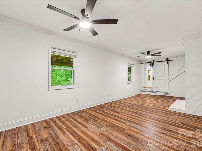 716 Grandview Drive, Concord, NC 28025.  MLS# CAR4390643, YatesRealty ID 28336. Expansive 312 square foot heated lower level space offering flexibility for work, play, hobbies, fitness, or additional living needs.