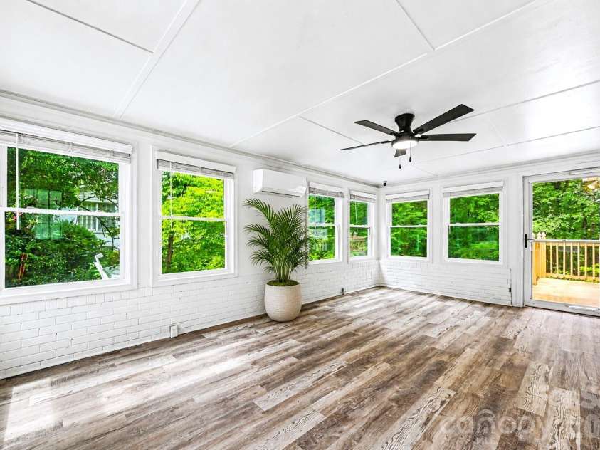 716 Grandview Drive, Concord, NC 28025.  MLS# CAR4390643, YatesRealty ID 28336. Light filled sunroom with its own mini split system, offering a comfortable space to relax, work, or entertain year round.