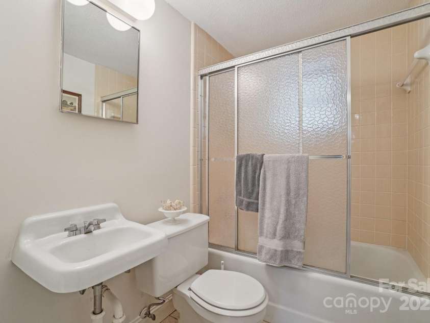 25 Hazel Court, Brevard, NC 28712.  MLS# CAR4277824, YatesRealty ID 28358. Convenient lower-level bathroom