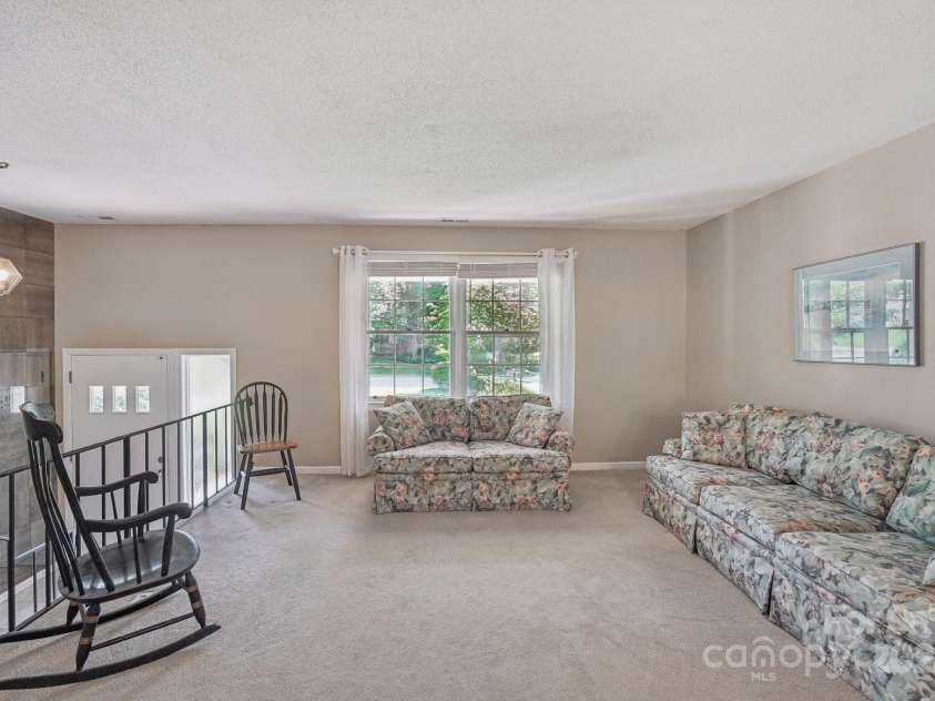 25 Hazel Court, Brevard, NC 28712.  MLS# CAR4277824, YatesRealty ID 28358. Gracious and open living area with refined, welcoming character