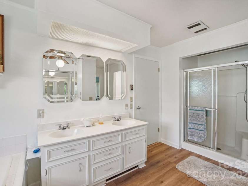 25 Hazel Court, Brevard, NC 28712.  MLS# CAR4277824, YatesRealty ID 28358. Lovely dual vanities and convenient walk-in shower
