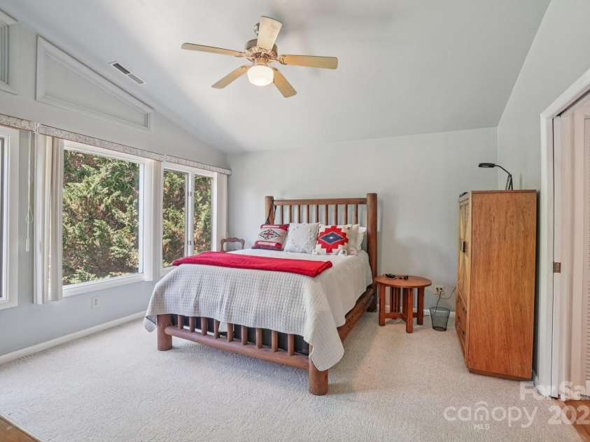 25 Hazel Court, Brevard, NC 28712.  MLS# CAR4277824, YatesRealty ID 28358. Retreat to the large primary bedroom