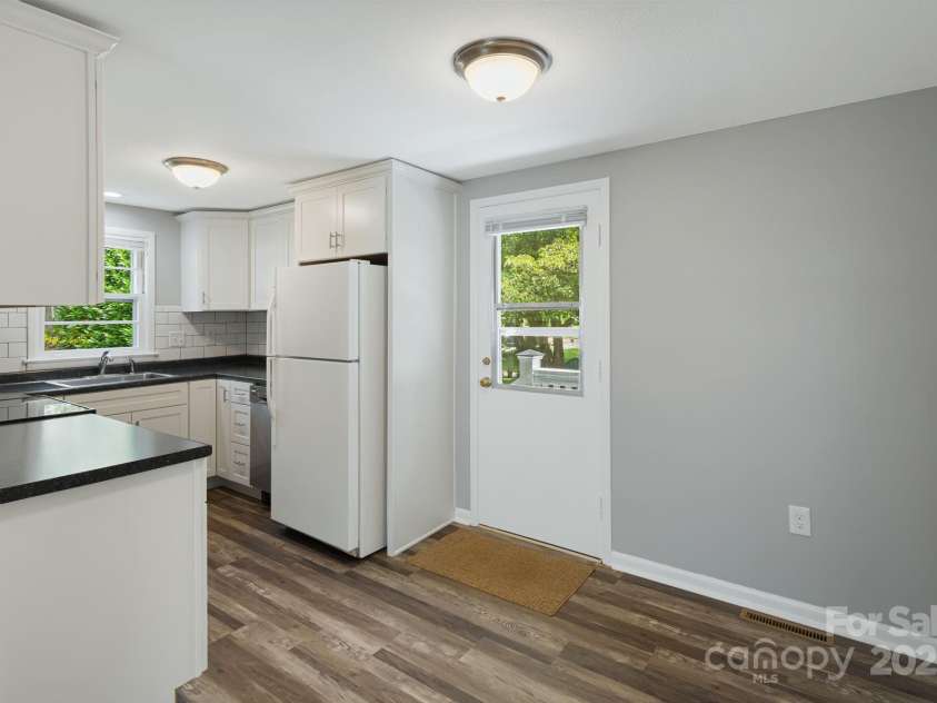 82 Maney Avenue, Asheville, NC 28804.  MLS# CAR4285420, YatesRealty ID 28365. New LVP flooring in the breakfast area that opens to the kitchen.