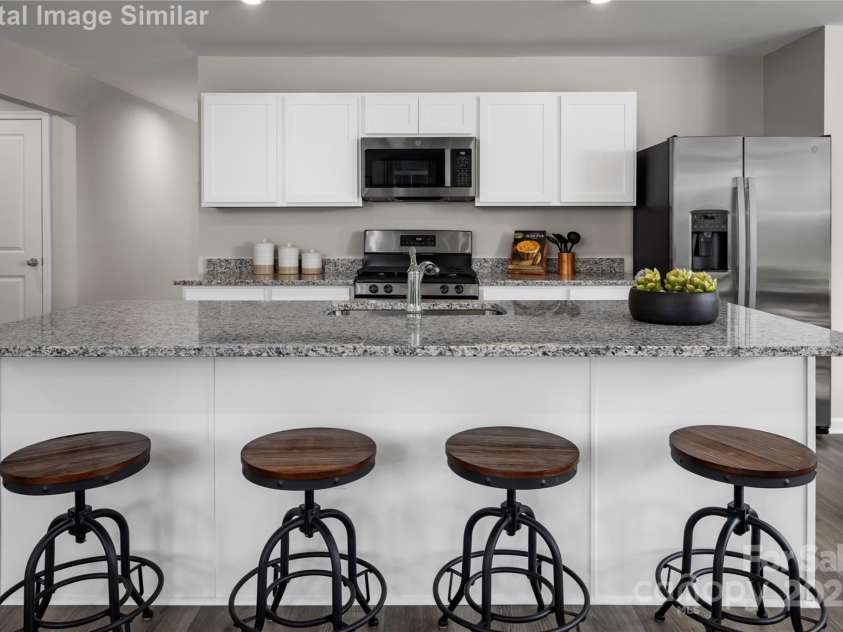 1813 Millstream Drive, China Grove, NC 28023.  MLS# CAR4248118, YatesRealty ID 28373. The Large Kitchen island is a perfect gathering area for meals or entertaining.