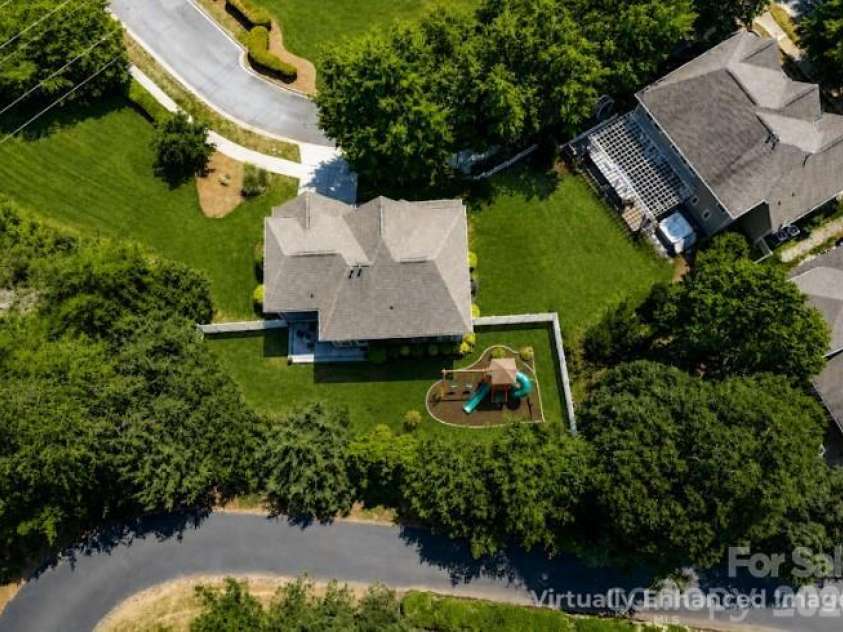 8611 Covedale Crossings Circle, Cornelius, NC 28031.  MLS# CAR4378956, YatesRealty ID 28395. Virtually Enhanced Image of Fenced Back Yard with playset.