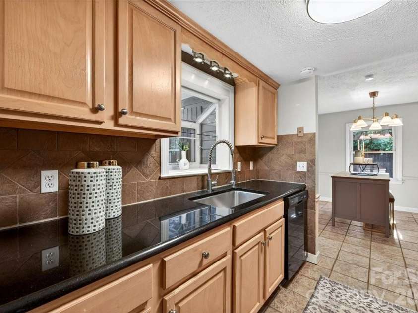 4330 Brookfield Drive, Charlotte, NC 28210.  MLS# CAR4383464, YatesRealty ID 28403. Galley kitchen with granite counters, ceramic tile floor and deep SS sink
