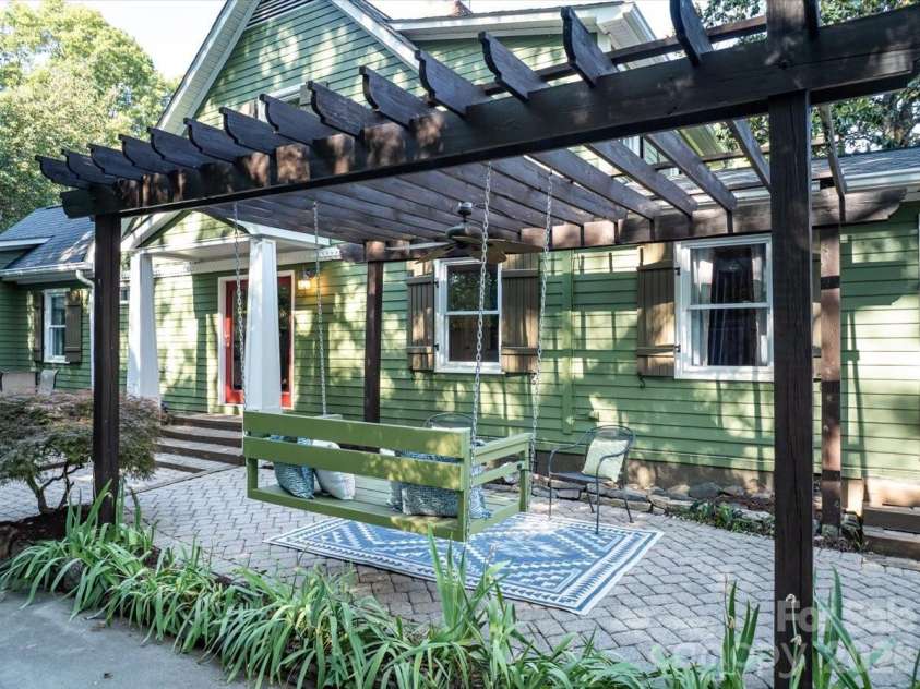 4330 Brookfield Drive, Charlotte, NC 28210.  MLS# CAR4383464, YatesRealty ID 28403. Pergola with built-in swing and seating area!