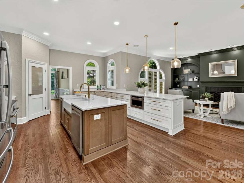 4725 Old Course Drive, Charlotte, NC 28277.  MLS# CAR4384171, YatesRealty ID 28405. A beautifully designed gourmet kitchen features dual oversized islands with quartz countertops, custom cabinetry, premium appliances, designer lighting, and seamless flow into the adjoining living spaces.