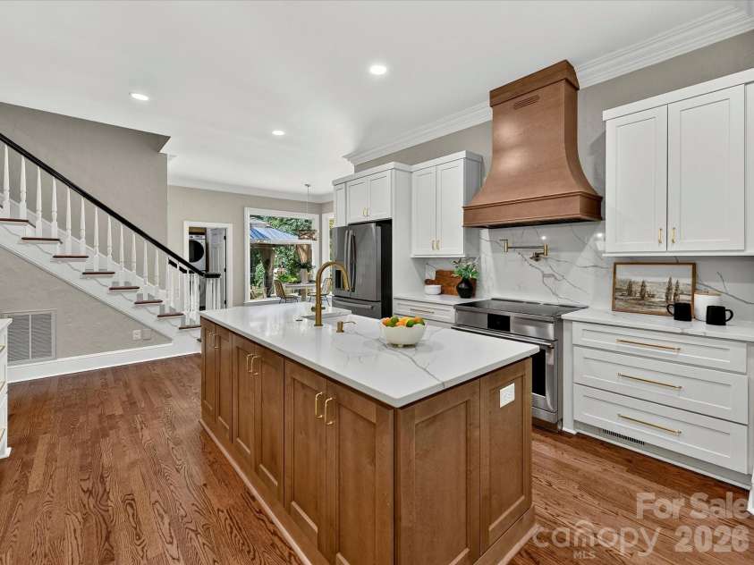 4725 Old Course Drive, Charlotte, NC 28277.  MLS# CAR4384171, YatesRealty ID 28405. A stunning gourmet kitchen showcases dual oversized quartz islands, custom cabinetry, premium stainless steel appliances, a designer range hood, abundant storage, and an open layout designed for effortless entertaini
