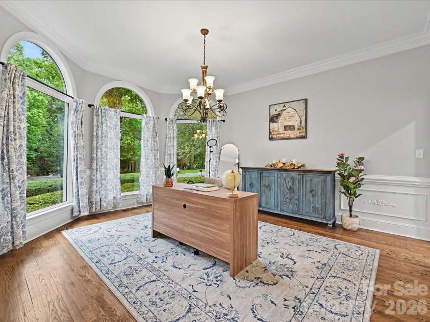 4725 Old Course Drive, Charlotte, NC 28277.  MLS# CAR4384171, YatesRealty ID 28405. A stunning home office features soaring ceilings, elegant crown molding, expansive arched windows, and beautiful natural light, creating an inspiring and sophisticated workspace.