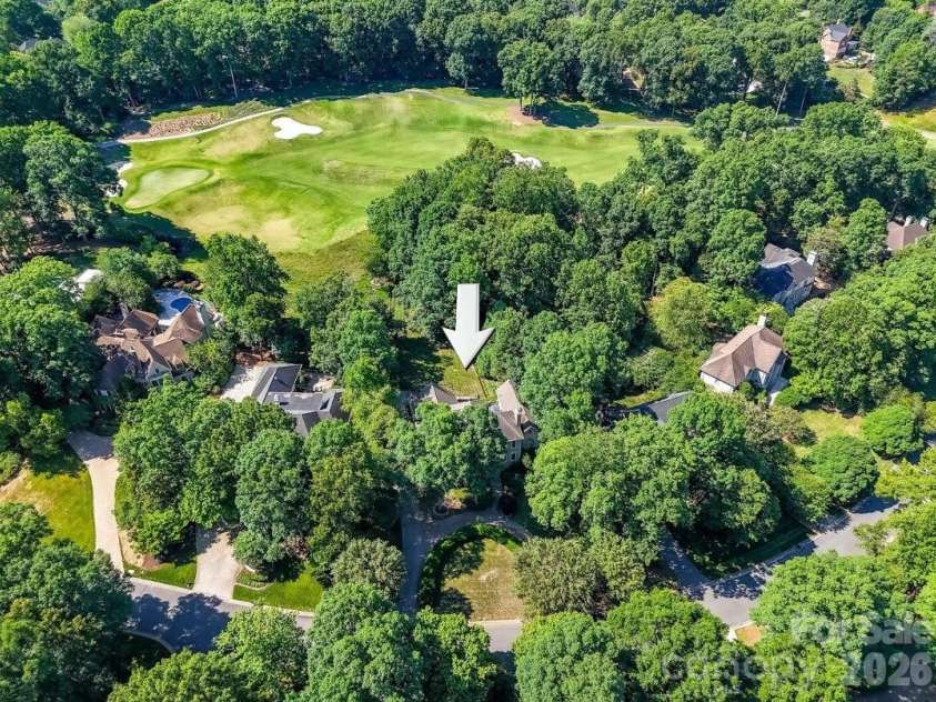 4725 Old Course Drive, Charlotte, NC 28277.  MLS# CAR4384171, YatesRealty ID 28405. Aerial view showcasing a private, wooded homesite backing to the golf course, offering exceptional privacy, mature trees, and a premier setting within an established luxury community.