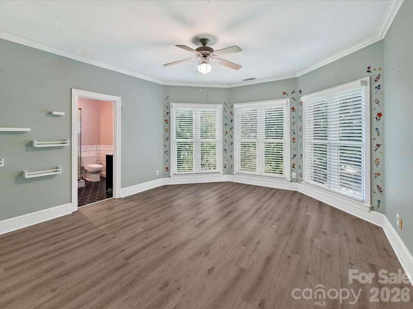4725 Old Course Drive, Charlotte, NC 28277.  MLS# CAR4384171, YatesRealty ID 28405. Bedroom 2 is generously sized and features abundant natural light, durable flooring, a private ensuite bath, and a versatile layout to comfortably accommodate family or guests.