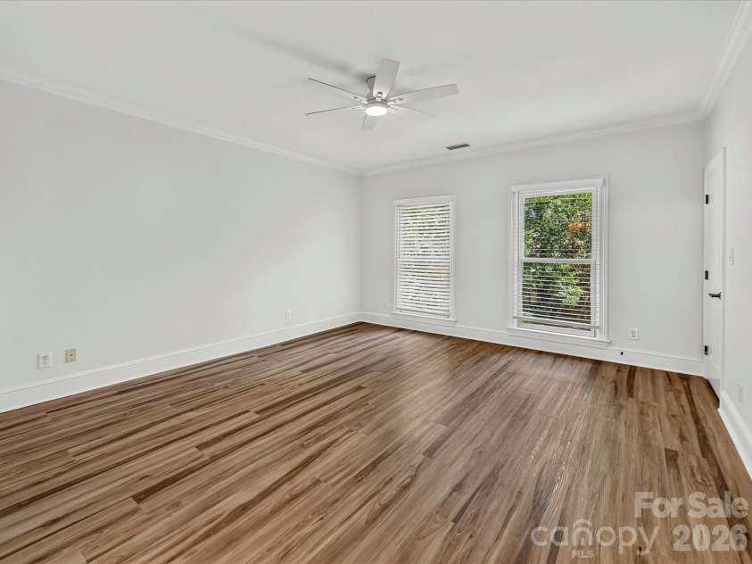 4725 Old Course Drive, Charlotte, NC 28277.  MLS# CAR4384171, YatesRealty ID 28405. Bedroom 4 features durable flooring, crown molding, abundant natural light, and a spacious layout that is perfect for family, guests, or a flexible home office.