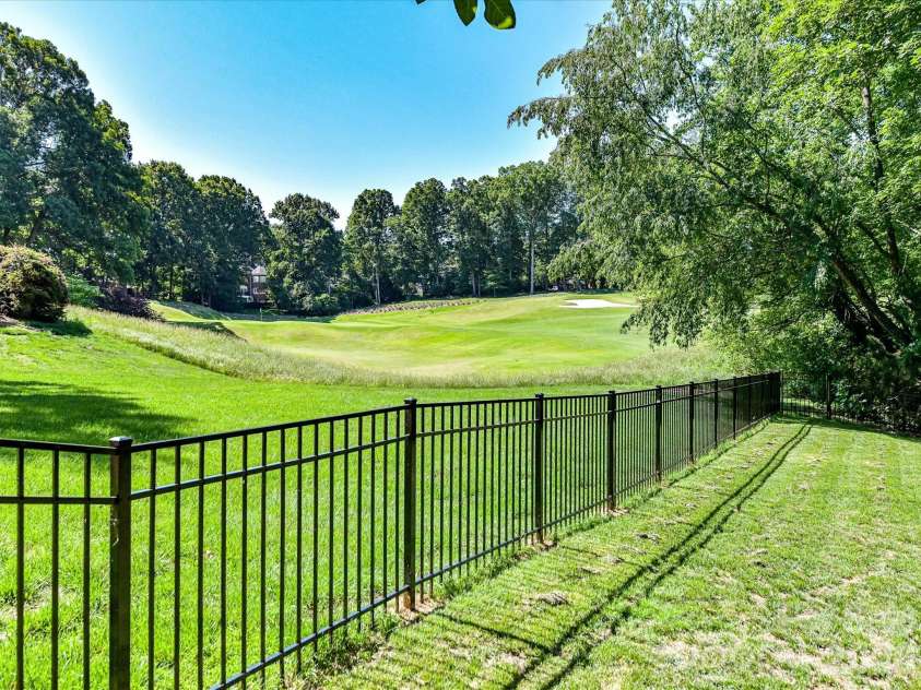 4725 Old Course Drive, Charlotte, NC 28277.  MLS# CAR4384171, YatesRealty ID 28405. The expansive, tree-lined backyard offers exceptional privacy, a fully fenced setting, and picturesque views extending toward the neighboring golf course.