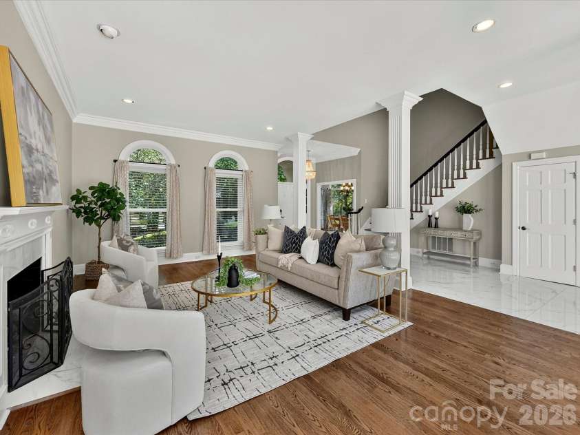 4725 Old Course Drive, Charlotte, NC 28277.  MLS# CAR4384171, YatesRealty ID 28405. The impressive Great Room showcases soaring ceilings, elegant architectural columns, a cozy fireplace, expansive gathering space, and seamless access to the outdoor living areas, creating the perfect setting for ever