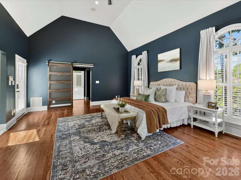 4725 Old Course Drive, Charlotte, NC 28277.  MLS# CAR4384171, YatesRealty ID 28405. The luxurious primary suite offers soaring vaulted ceilings, elegant arched windows, abundant natural light, generous space for a private sitting area, and a serene retreat designed for comfort and relaxation.