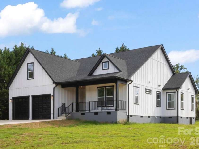 2589 Polo Lane, Maiden, NC 28650.  MLS# CAR4299931, YatesRealty ID 28419. Corner view of home. The left side of the lot has large cypress tress lined all the way for privacy. The right side of the lot has solid wood privacy fence. No HOA so you can put the rest of a fence up no approval needed.