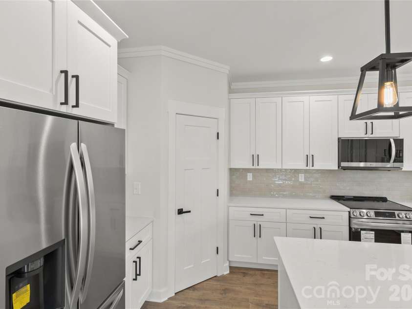 2589 Polo Lane, Maiden, NC 28650.  MLS# CAR4299931, YatesRealty ID 28419. The pendants over the island feauture lights that shine on ceiling for mood lighting. The main bulb lights up and also there is an LED lower ring on bottom of light for more light or to be used at night time.