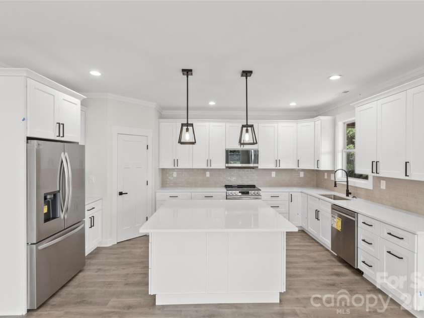 2589 Polo Lane, Maiden, NC 28650.  MLS# CAR4299931, YatesRealty ID 28419. This angle shows how large the island is. This is the large island you dream of in your kitchen. View from living room of the open kitchen. LG upgraded appliances. Premium Refrigerator and blue ceramic inside slide in range