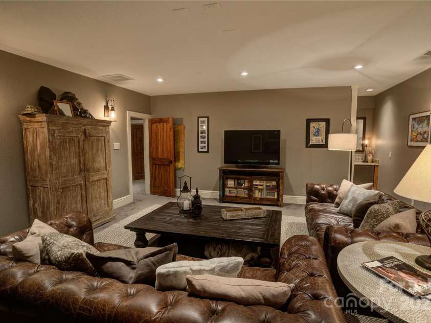 29 Bonnie Brae Drive, Weaverville, NC 28787.  MLS# CAR4266285, YatesRealty ID 28435. Basement level entertainment room wired for projection screen and includes a mini wet bar.