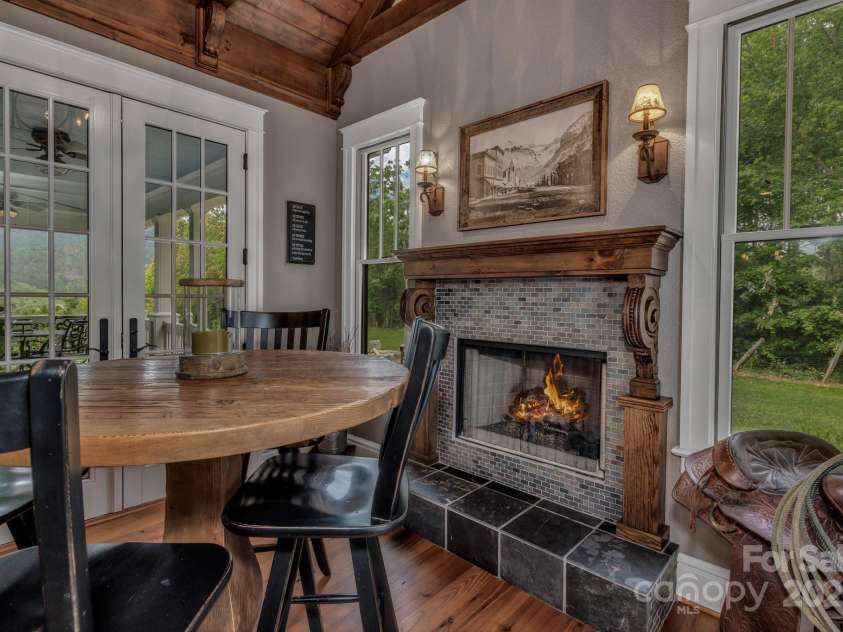 29 Bonnie Brae Drive, Weaverville, NC 28787.  MLS# CAR4266285, YatesRealty ID 28435. Fireside Breakfast Alcove with vaulted ceilings, cutom reclaimed wooden corbels and direct access of the kitchen and out to the covered side porch