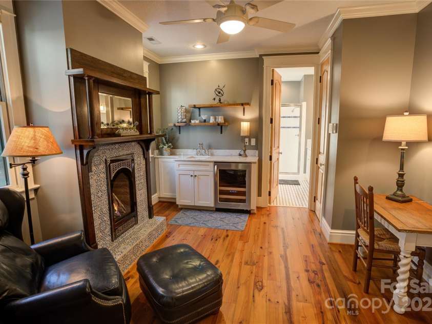29 Bonnie Brae Drive, Weaverville, NC 28787.  MLS# CAR4266285, YatesRealty ID 28435. Upper level guest suite #1 sitting area with fireplace and kitchenette.