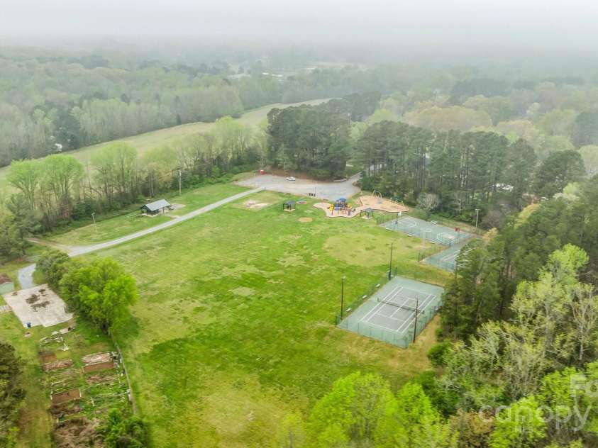 6807 Stoney Ridge Road, Matthews, NC 28104.  MLS# CAR4241286, YatesRealty ID 28444. Pond to fish in