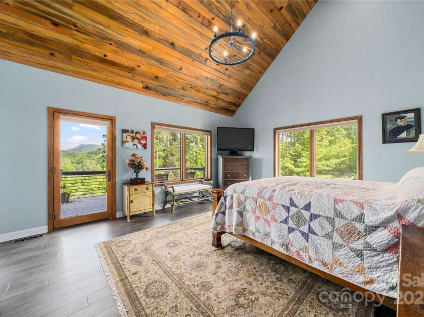 134 Olivia Trace Drive, Fletcher, NC 28732.  MLS# CAR4257309, YatesRealty ID 28446. Primary bedroom with access to the rear deck for a late night visit to the hot tub with touch of a button electronic lid for ultimate convenience