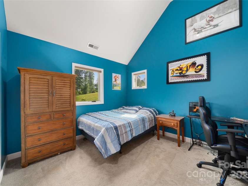 134 Olivia Trace Drive, Fletcher, NC 28732.  MLS# CAR4257309, YatesRealty ID 28446. Upper level bedroom three with cathedral ceilings and large closets