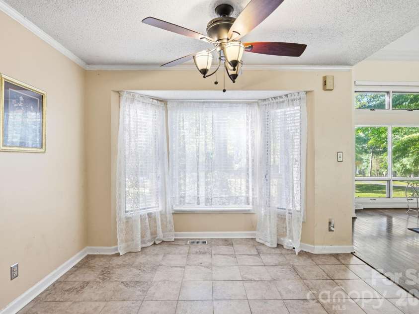1775 Apple Tree Lane, Fort Mill, SC 29715.  MLS# CAR4380119, YatesRealty ID 28448. Dining Area with Bay Window overlooking front deck area and trees.