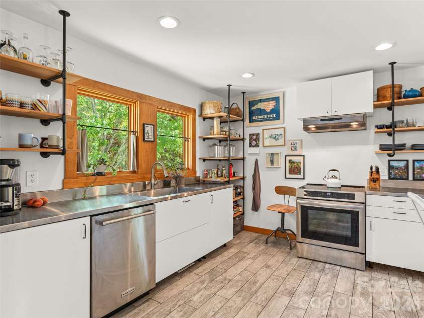 241 Pinners Cove Road, Asheville, NC 28803.  MLS# CAR4385845, YatesRealty ID 28453. Kitchen with open shelving & stainless appliances