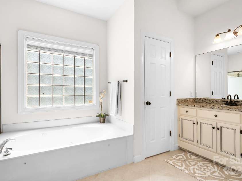 16028 Hallaton Drive, Huntersville, NC 28078.  MLS# CAR4254854, YatesRealty ID 28460. Primary bathroom with separate vanities, tub and shower