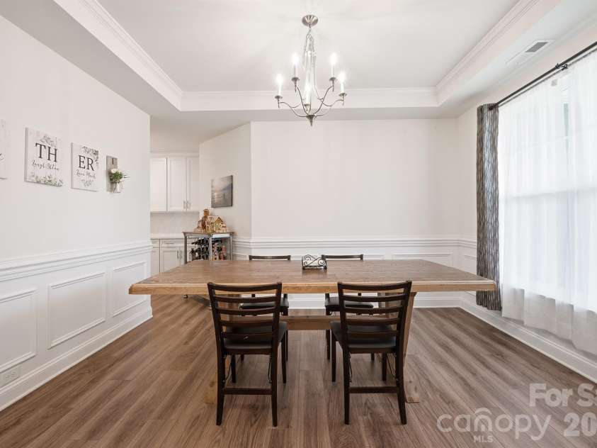 282 Bouchard Drive, Waxhaw, NC 28173.  MLS# CAR4387883, YatesRealty ID 28465. Dining Room Featuring Tray Ceilings and Wainscoting