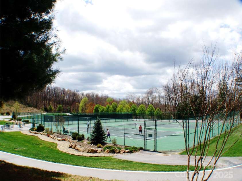 66 Ottaray Court, Brevard, NC 28712.  MLS# CAR4280807, YatesRealty ID 28466. Clay tennis courts surrounded by a level walking track
