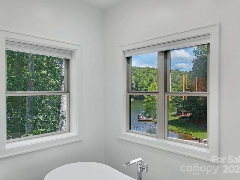 66 Ottaray Court, Brevard, NC 28712.  MLS# CAR4280807, YatesRealty ID 28466. Lake views from freestanding tub