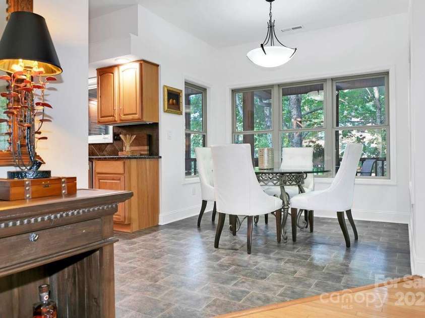 66 Ottaray Court, Brevard, NC 28712.  MLS# CAR4280807, YatesRealty ID 28466. Living room flows seamlessly into dining area & kitchen