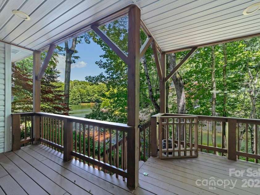 66 Ottaray Court, Brevard, NC 28712.  MLS# CAR4280807, YatesRealty ID 28466. Lower-level, lakeside covered porch