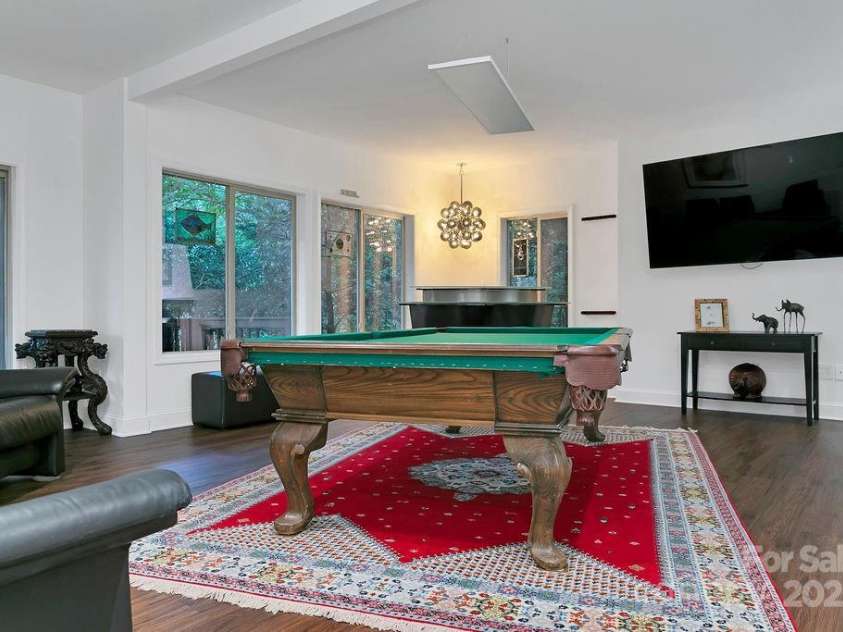 66 Ottaray Court, Brevard, NC 28712.  MLS# CAR4280807, YatesRealty ID 28466. Lower level living area is currently a billiards room