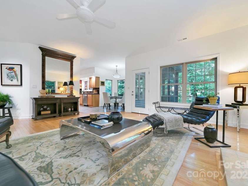 66 Ottaray Court, Brevard, NC 28712.  MLS# CAR4280807, YatesRealty ID 28466. Main level screened porch connected to living room