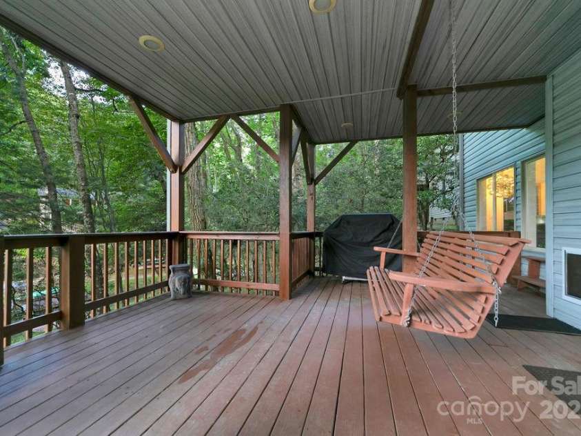 66 Ottaray Court, Brevard, NC 28712.  MLS# CAR4280807, YatesRealty ID 28466. Porch swing with lake views on lower-level deck