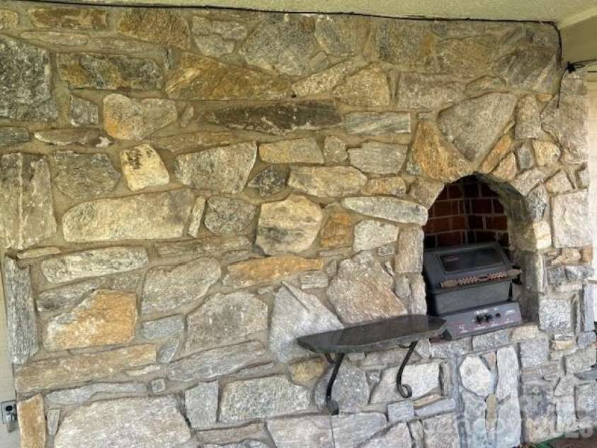 30 Brier Lane, Maggie Valley, NC 28751.  MLS# CAR4320298, YatesRealty ID 2847. Fireplace on back porch