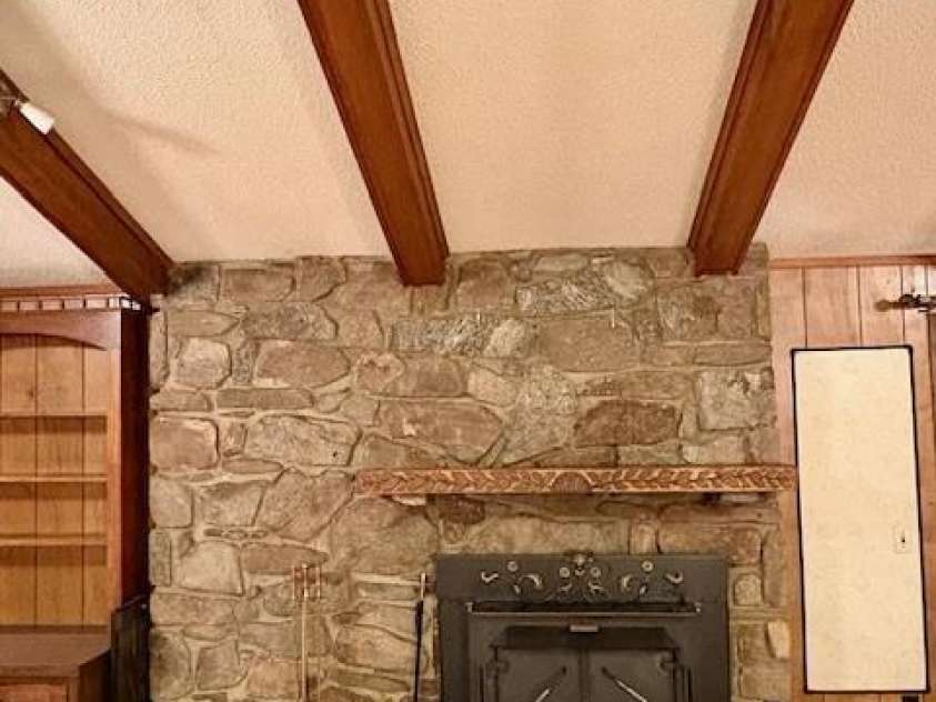 30 Brier Lane, Maggie Valley, NC 28751.  MLS# CAR4320298, YatesRealty ID 2847. Wood stove/fireplace; with native stone backdrop