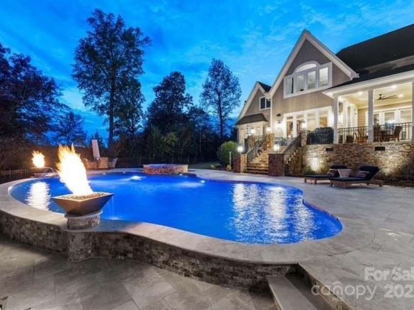 6216 North Road, York, SC 29745.  MLS# CAR4270896, YatesRealty ID 28499. Gas torches illuminate night swimming